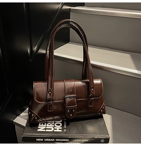 Detailed view of deep brown vintage faux leather shoulder bag with silver buckle and studs