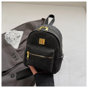 Close-up of mini vintage backpack showing matte texture and gold hardware details