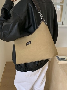 Retro khaki frosted leather tote bag with Lucy Breeze logo in a minimalist setting