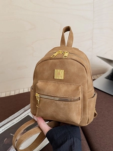 Retro brown mini backpack in faux suede with gold hardware and multiple pockets