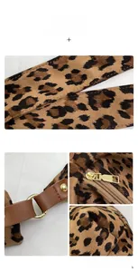 Detailed macro view of leopard print suede fabric with gold metal rings and leather straps