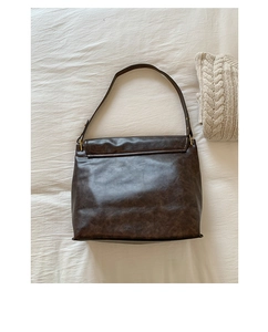 Grand sac cabas rétro marron foncé avec finition texturée sur fond de tissu beige