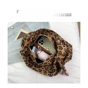 Detailed interior of leopard print tote bag showing spacious compartments and storage