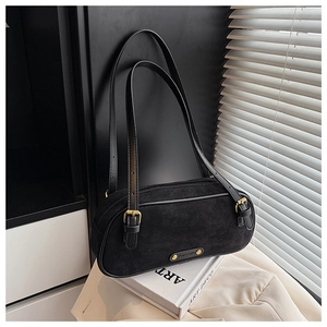 Detail of black suede Boston bag featuring adjustable gold buckle and zipper closure