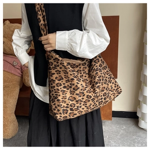 Close-up of leopard print tote bag with wide shoulder strap and durable fabric detail
