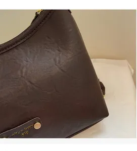 Close-up of vintage brown leather bag detail with soft texture and Fashion Trend rivets