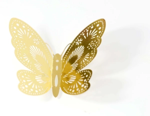 Close-up of 3D rose gold butterfly wall sticker with hollow laser-cut geometric patterns