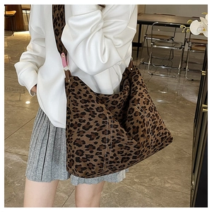 Detail of leopard print tote bag featuring white contrast stitching and canvas texture