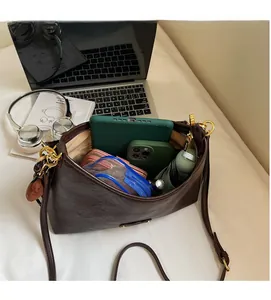 Spacious interior of brown leather hobo bag showing daily essentials and large capacity