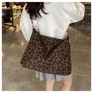 Detail of leopard print tote bag showing white vertical stitching and matte texture