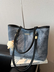 Blue denim texture tote bag with black handles and cute plush sheep charm decoration