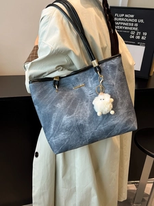 Large blue-grey marble tote bag with black leather trim and cute furry monster charm