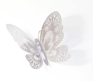 Detail of 3D silver butterfly wall sticker with intricate laser cut hollow pattern