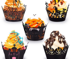 Detail of black laser-cut Halloween cupcake liners with spider web and castle patterns