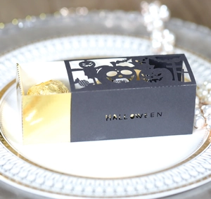 Macro shot of Halloween hollow candy box with bat patterns and gold mirror drawer