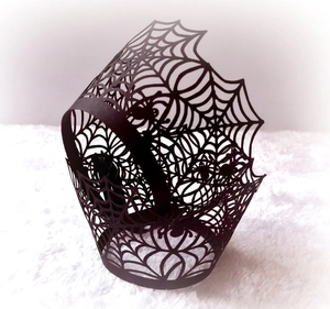 Laser-cut black spider web cupcake wrappers for Halloween party table decorations