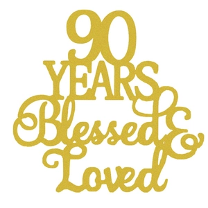 Detail of 90 Years Blessed & Loved gold glitter cake topper with champagne gold finish