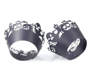 Halloween cupcake wrappers featuring laser-cut pumpkin, bat, and ghost motifs in black paper