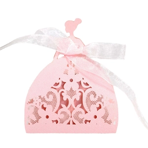 Pink laser-cut dress-shaped wedding candy box with a white ribbon bow on white background