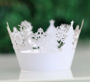 Detailed laser-cut Christmas cupcake wrappers with white snowflake and reindeer patterns