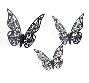 Close-up of laser-cut black hollow butterfly wall stickers with 3D floral patterns