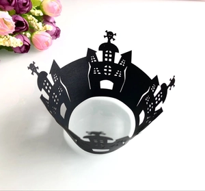 Detailed laser-cut black cupcake wrapper featuring a spooky Halloween castle and skull pattern