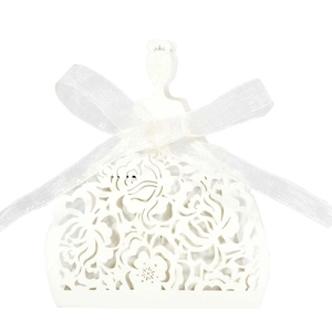 Detailed laser cut white cardstock favor box with elegant floral patterns and silk ribbon bow