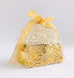 Macro detail of laser-cut rose patterns on the golden hollow wedding favor box