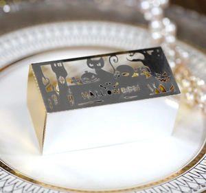 Detail of silver laser-cut Halloween gift box with bat and pumpkin hollow patterns