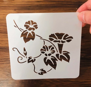 Close-up of flexible PET stencil featuring a laser-cut morning glory flower design