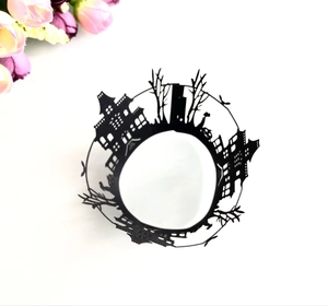 Intricate laser-cut black Halloween cupcake wrappers with haunted castle and bat designs