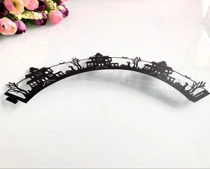 Detail of laser-cut Halloween cupcake wrappers featuring haunted castle and tree silhouettes