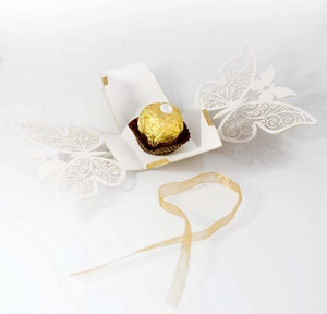 Laser cut butterfly candy box with white pearlescent texture and gold ribbon detail