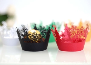Laser cut Christmas cupcake liners featuring snowflake and reindeer patterns in multiple colors
