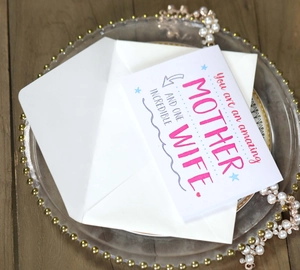 Floral Mother's Day card with white envelope for wives and moms on a glass tray