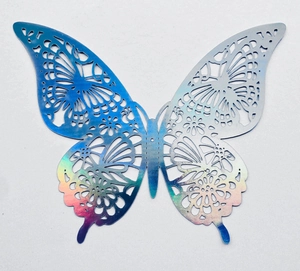 Macro shot of 3D hollow laser butterfly decoration with iridescent colorful finish