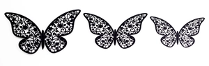 Detail of three black laser-cut 3D butterfly wall stickers with intricate floral patterns