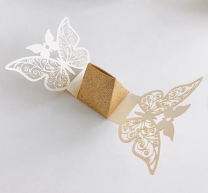 Macro shot of laser-cut butterfly gift box with golden glitter paper center
