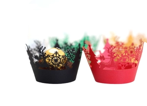 Laser-cut Christmas cupcake wrappers featuring reindeer and snowflake holiday patterns
