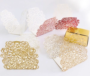 Detailed laser cut rose patterns on glittery paper favor boxes in multiple colors