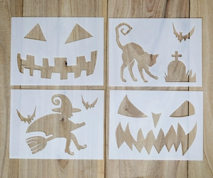 Halloween stencil set with pumpkin, witch, and bat designs on a wooden background