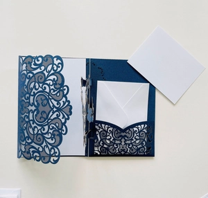 Detail of laser-cut floral patterns on dark blue pearlescent paper invitation set