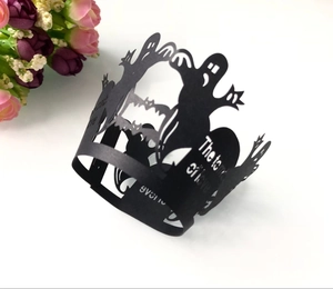 Black laser-cut Halloween cupcake liners with ghosts, bats, and gravestone patterns