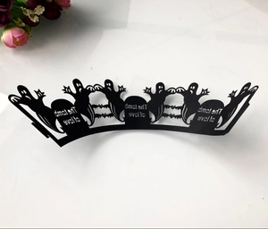 Detail of laser-cut black Halloween cupcake wrappers featuring spooky tombstone and bats