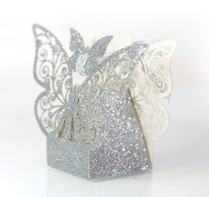Detail view of silver glitter butterfly hollow favor box with light purple silk ribbon