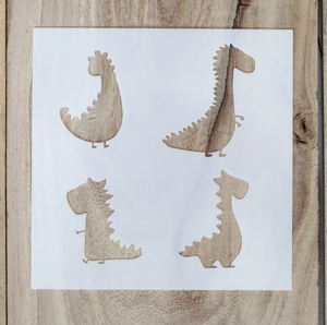 Close-up of four white plastic dinosaur stencils for DIY painting on a light wood background