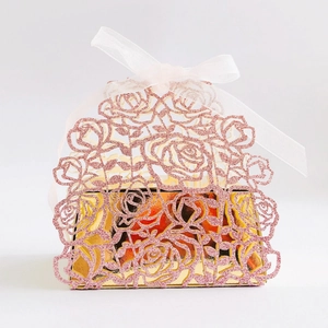 Pink glitter laser-cut rose favor box with white ribbon and golden lining for weddings