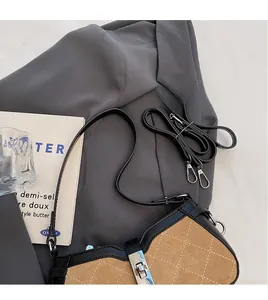 Detailed close-up of retro contrast crossbody bag featuring khaki suede and black leather