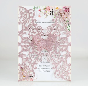 Detailed laser-cut butterfly invitation with pink glitter finish and floral inner page