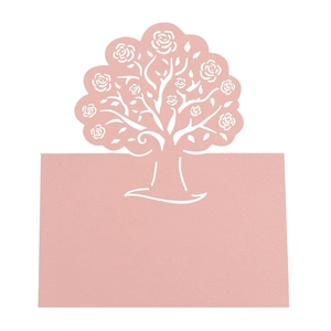 Detailed laser-cut pink tree design on a wedding place card with hollow rose patterns